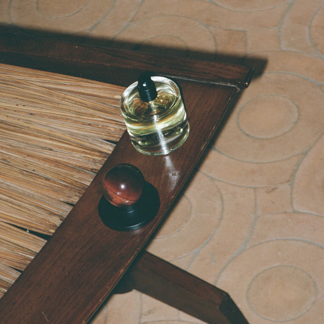 Agati bottle with cap sitting on a rustic chair, artistically photographed on film
