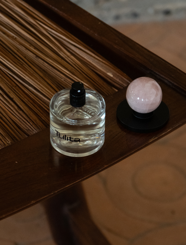 Vikasa bottle open with crystal cap sitting on a rustic chair. Photographed using film.